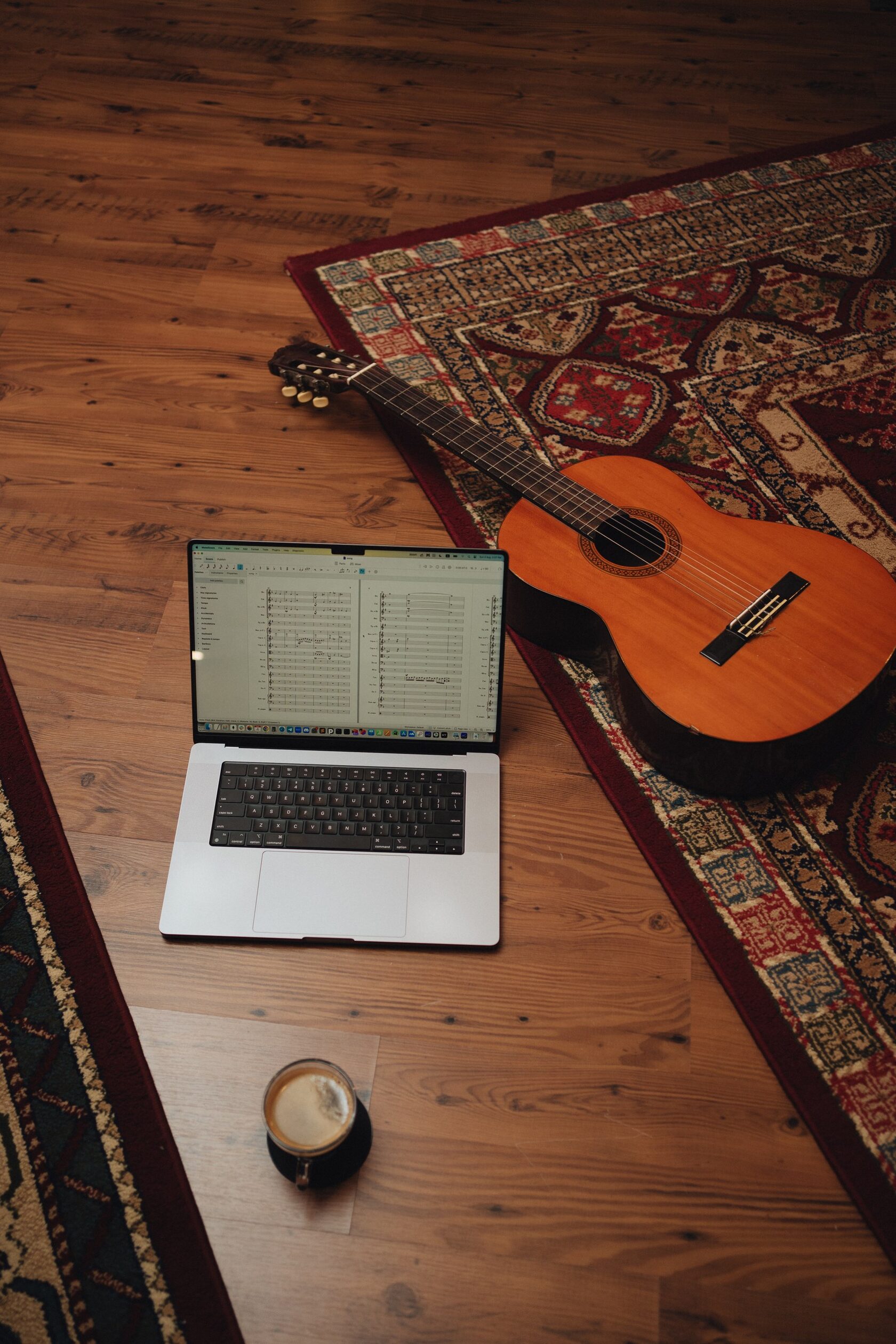 Laptop with music notation and guitar